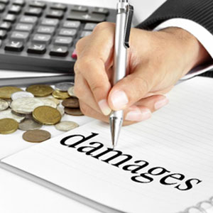 Hand pointing to "Damages" with calculator and coin nearby, representing complexity of calculating damages - Titus Law Firm